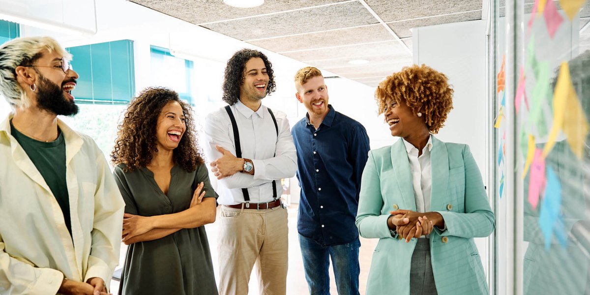 HR executive standing and providing sexual harassment in the workplace training to a room of young employees.