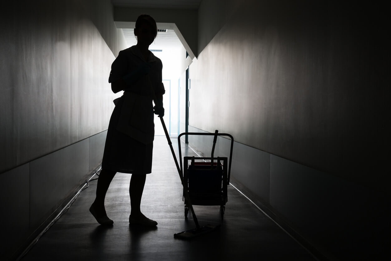 Silhouette Of Maid Cleaning Floor