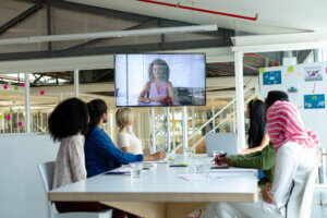 diverse business team sitting in on instructor-led video conference webinar workplace training session