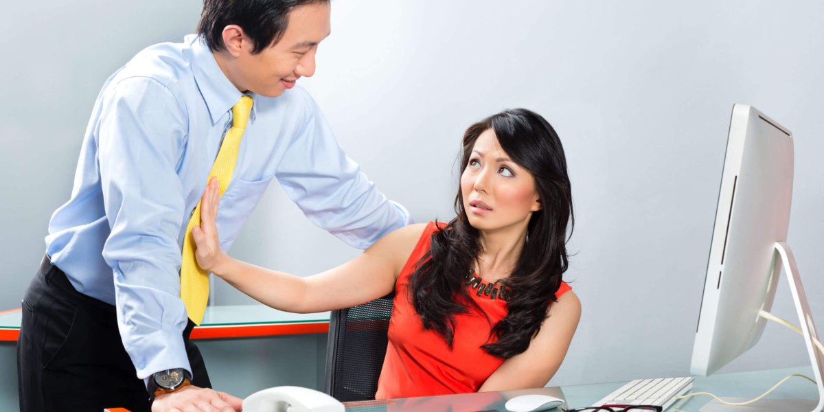 Asian Woman Rejecting Asian Man's Unwanted Advance Towards Her at Work