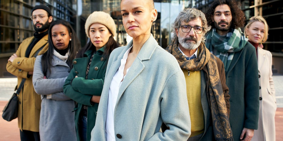 A group of serious employees standing outside and empowered by sexual harassment prevention training
