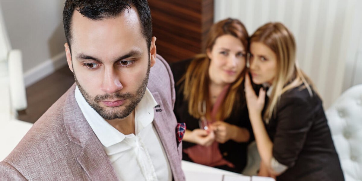 Women Gossiping About Ethnic Male Coworker