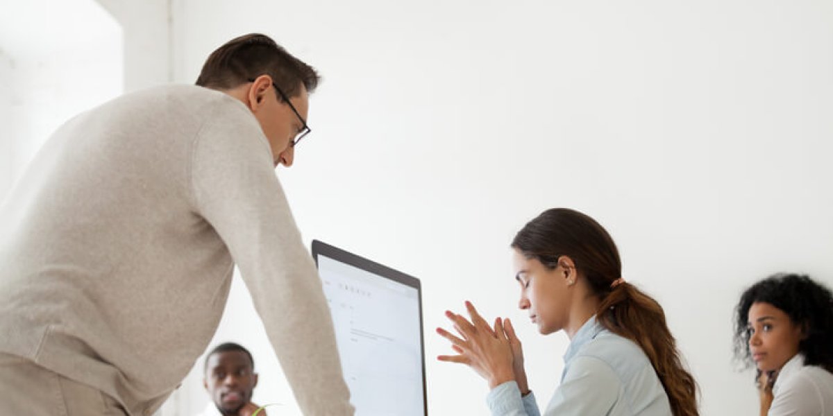 Manager displaying microaggressions towards employees in mulitracial office space