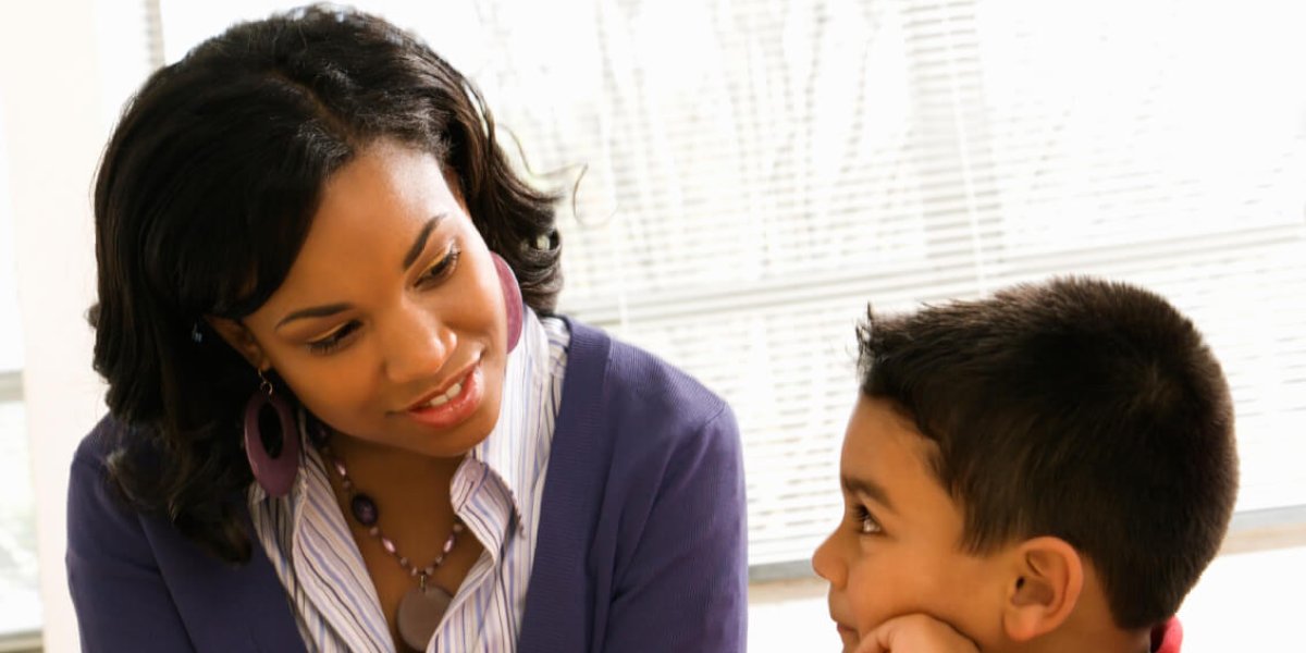 Teacher Helping Boy With Schoolwork