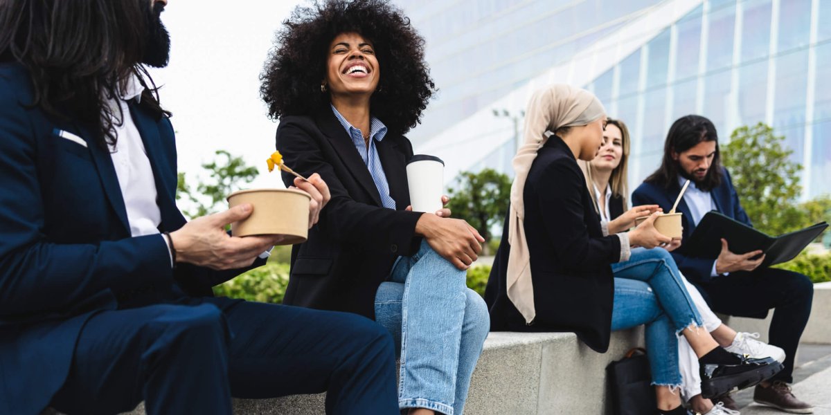 Multiracial business people taking a break and eating a meal outside the office