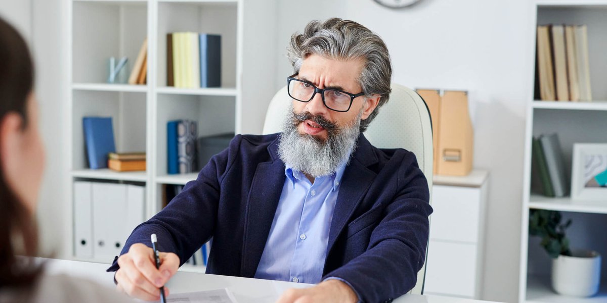 Serious hr manager in a employee workplace discipline meeting