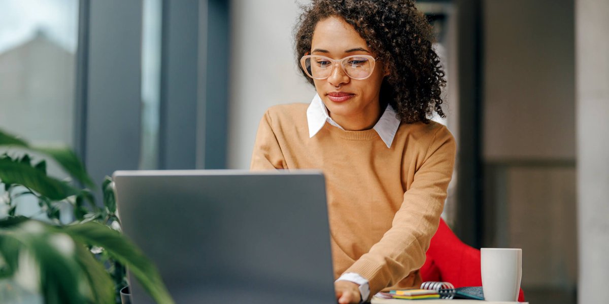 Young stylish business women taking online sexual harassment training on her work laptop