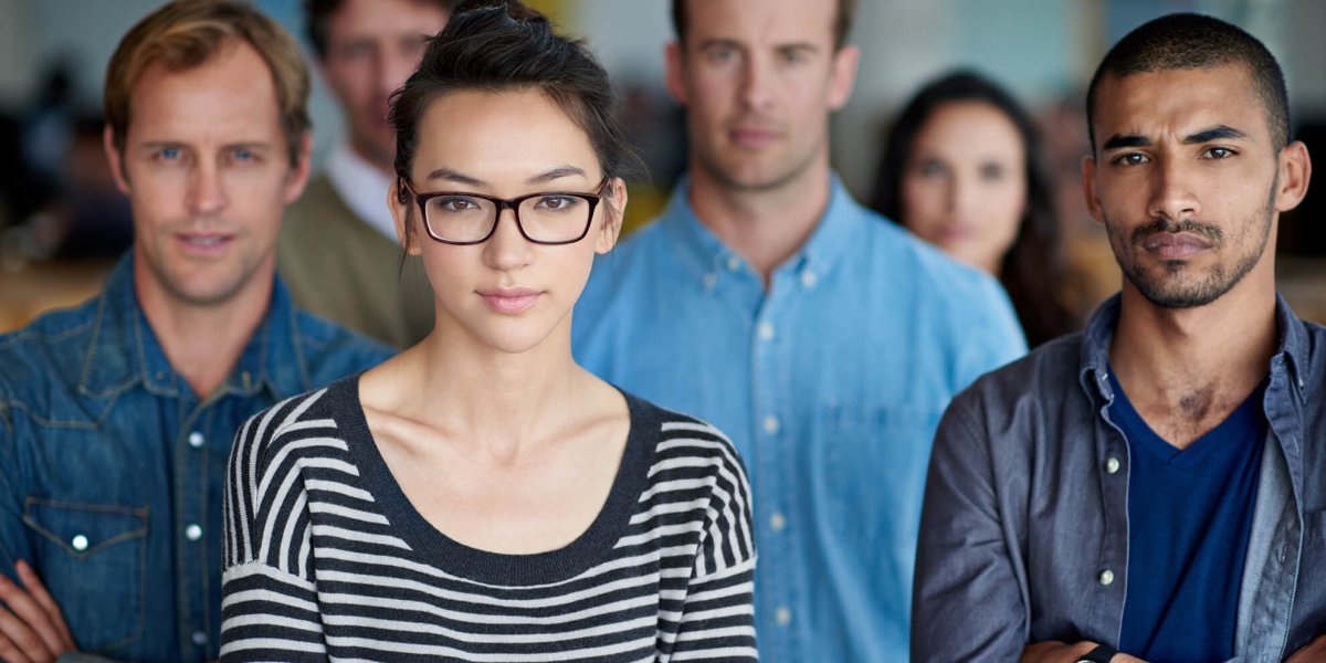 Diverse work team with serious faces standing up for sexual harassment prevention training